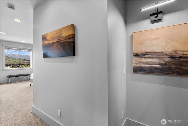 hallway featuring baseboards, recessed lighting, and carpet