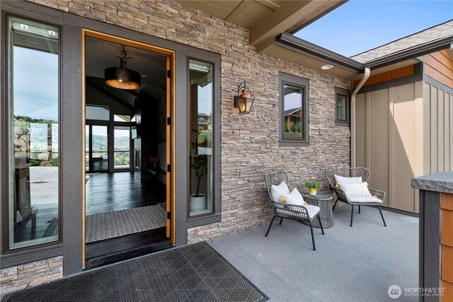 doorway to property featuring stone siding