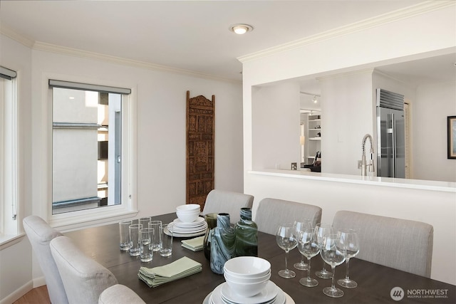 dining space with crown molding