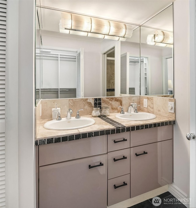 bathroom featuring a sink and double vanity