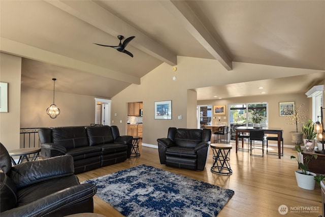 living room with light wood-style floors, baseboards, and lofted ceiling with beams