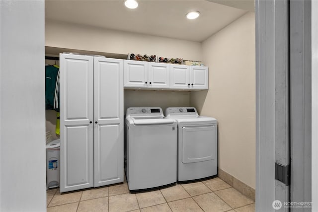 laundry area with cabinet space, light tile patterned floors, baseboards, recessed lighting, and washer and clothes dryer