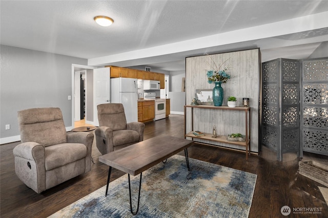 living room with dark wood-type flooring and baseboards