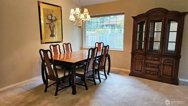 dining room with plenty of natural light, carpet flooring, a textured wall, and an inviting chandelier