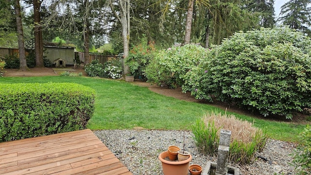 view of yard with fence and an outbuilding
