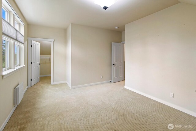 1740 NE Nutkana Way, Poulsbo, WA 98370 - spare room featuring radiator heating unit, light carpet, and baseboards