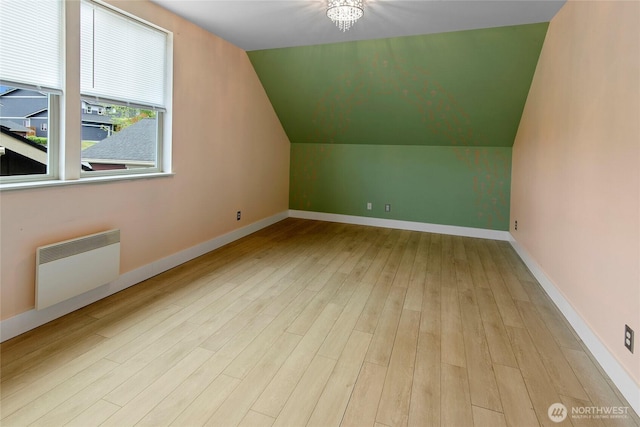 1740 NE Nutkana Way, Poulsbo, WA 98370 - additional living space featuring radiator, wood finished floors, lofted ceiling, and baseboards