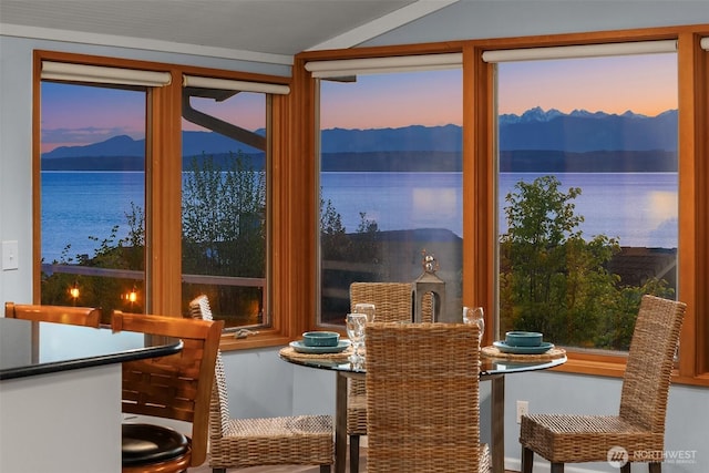 dining area with a water and mountain view