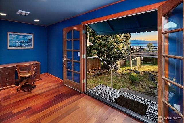 doorway to outside with baseboards, visible vents, hardwood / wood-style flooring, and recessed lighting