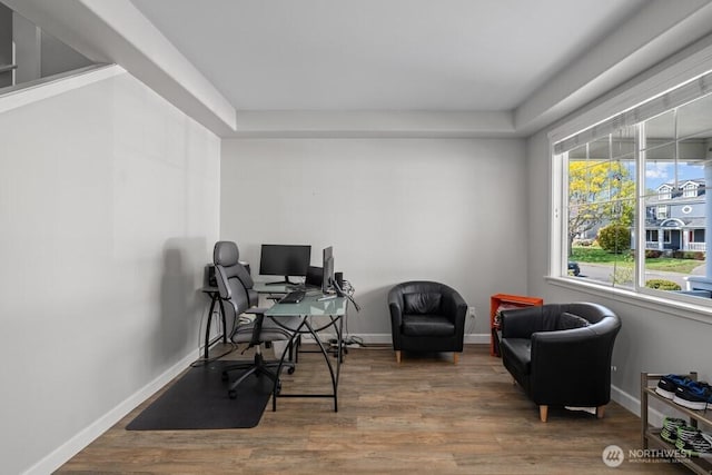office space featuring baseboards and wood finished floors