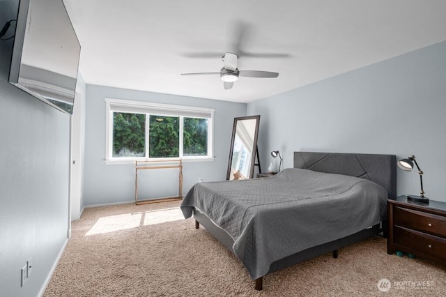 carpeted bedroom with baseboards and a ceiling fan