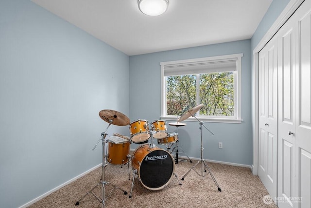 game room with baseboards and carpet flooring