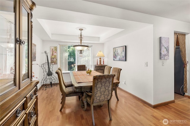 13103 SE 261st Pl, Kent, WA 98030 - dining area featuring light wood-style floors, baseboards, and a tray ceiling