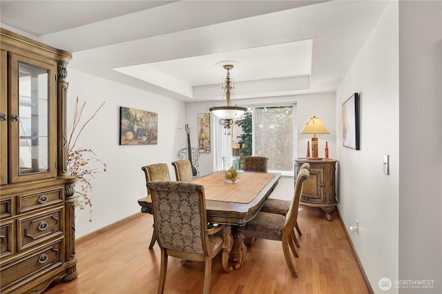 13103 SE 261st Pl, Kent, WA 98030 - dining area with baseboards, light wood finished floors, and a tray ceiling