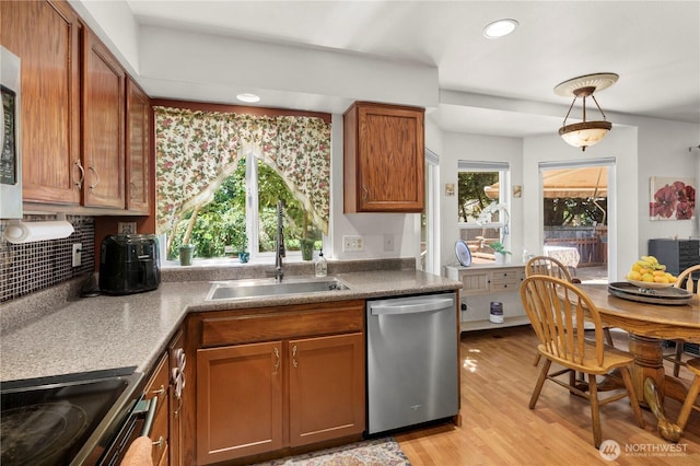 13103 SE 261st Pl, Kent, WA 98030 - kitchen featuring brown cabinetry, dishwasher, a sink, light wood finished floors, and electric stove