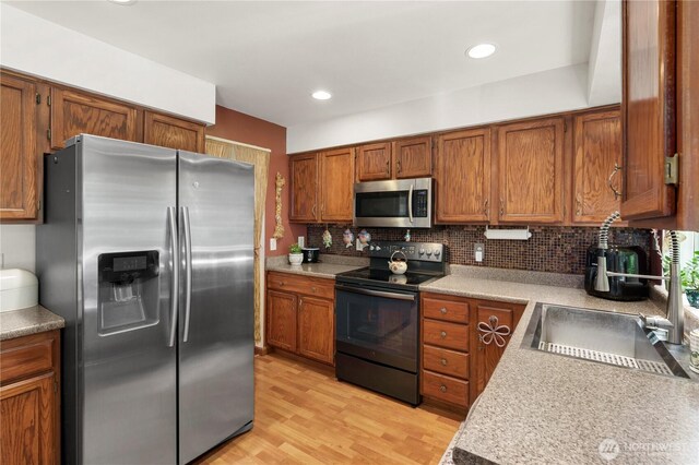 13103 SE 261st Pl, Kent, WA 98030 - kitchen with a sink, tasteful backsplash, brown cabinets, and stainless steel appliances