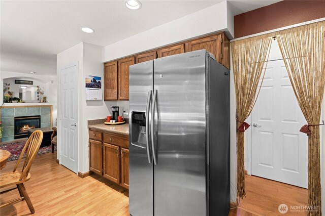 13103 SE 261st Pl, Kent, WA 98030 - kitchen with brown cabinetry, stainless steel fridge with ice dispenser, and light wood-style floors
