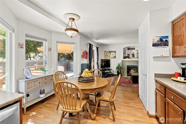 13103 SE 261st Pl, Kent, WA 98030 - dining room featuring light wood-type flooring and a tile fireplace