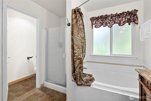 13103 SE 261st Pl, Kent, WA 98030 - bathroom with baseboards, a bath, a stall shower, and toilet