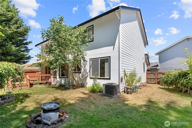 13103 SE 261st Pl, Kent, WA 98030 - back of house with a lawn, fence, a wooden deck, and central AC unit