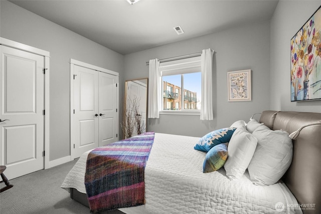 bedroom featuring visible vents, carpet, and a closet