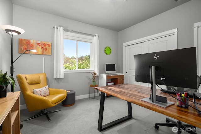 carpeted office space with baseboards