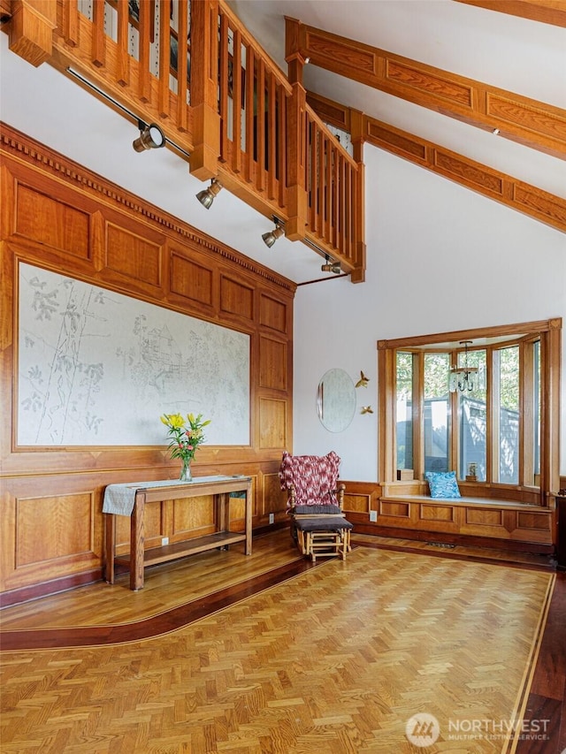 4385 Wildwood Ln, Anacortes, WA 98221 - sitting room with high vaulted ceiling, beamed ceiling, and wainscoting