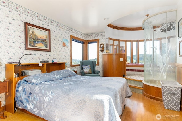 4385 Wildwood Ln, Anacortes, WA 98221 - bedroom with wallpapered walls and hardwood / wood-style floors