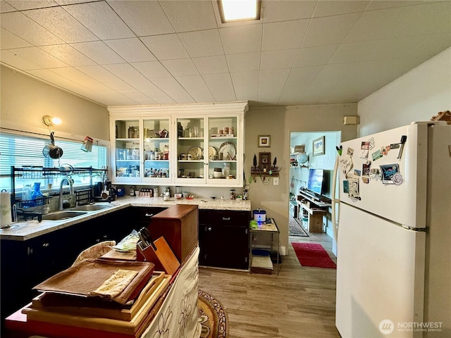 711 E Dayton Ave, Dayton, WA 99328 - kitchen featuring light countertops, light wood-style flooring, freestanding refrigerator, and a sink