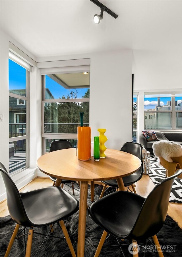 dining area with wood finished floors
