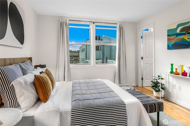 bedroom featuring baseboards and light wood-style floors