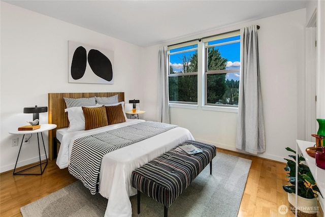 bedroom with wood finished floors and baseboards
