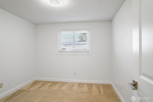 8305 NW Fruit Valley Rd, Vancouver, WA 98665 - unfurnished room featuring light colored carpet, visible vents, a textured ceiling, and baseboards