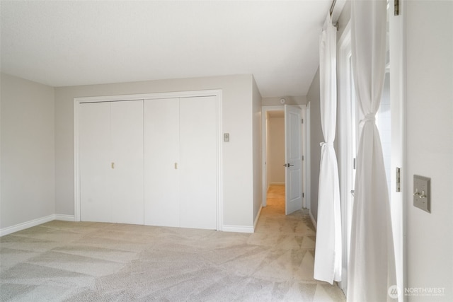 8305 NW Fruit Valley Rd, Vancouver, WA 98665 - unfurnished bedroom with a closet, light carpet, and baseboards