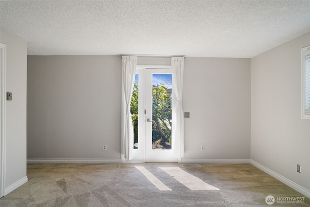 8305 NW Fruit Valley Rd, Vancouver, WA 98665 - carpeted empty room featuring a textured ceiling, visible vents, and baseboards
