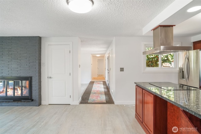 8305 NW Fruit Valley Rd, Vancouver, WA 98665 - hall with a textured ceiling, light wood-style flooring, and baseboards