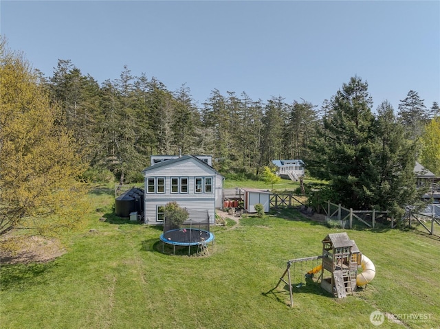 486 Wren Rd, Lopez Island, WA 98261 - view of yard with a playground, a trampoline, an outbuilding, a storage shed, and fence