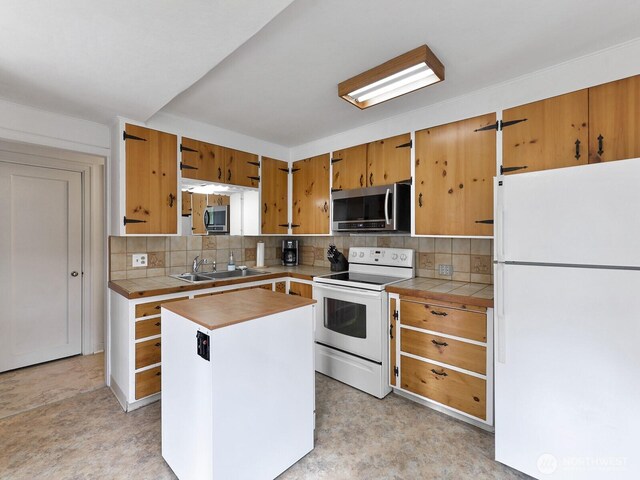 kitchen with a sink, decorative backsplash, tile counters, and white appliances