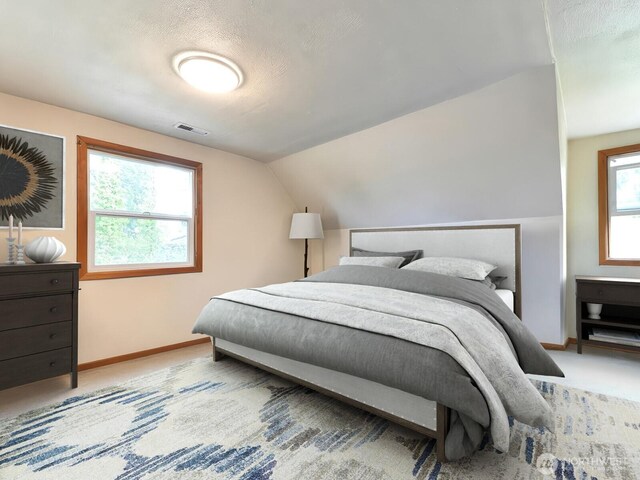 bedroom featuring visible vents, baseboards, carpet floors, and vaulted ceiling