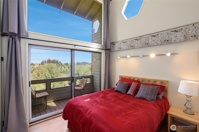 bedroom featuring multiple windows and a towering ceiling