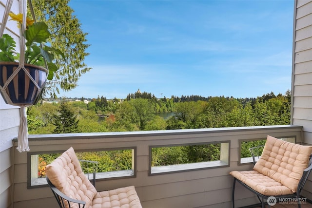 balcony featuring a view of trees