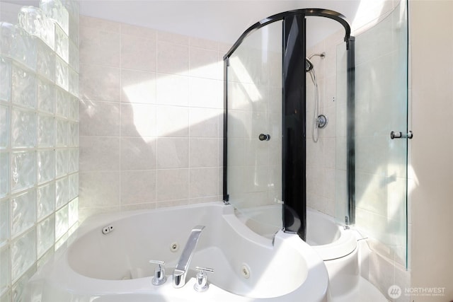 full bathroom featuring a tub with jets and tiled shower
