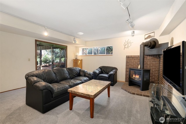 carpeted living room with track lighting and a wood stove