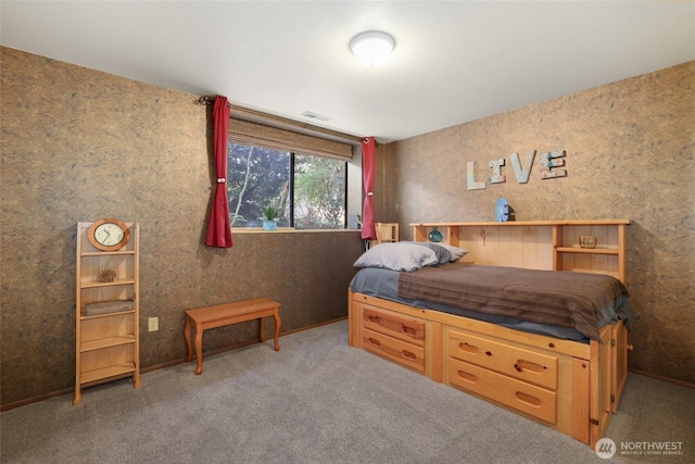 carpeted bedroom featuring visible vents