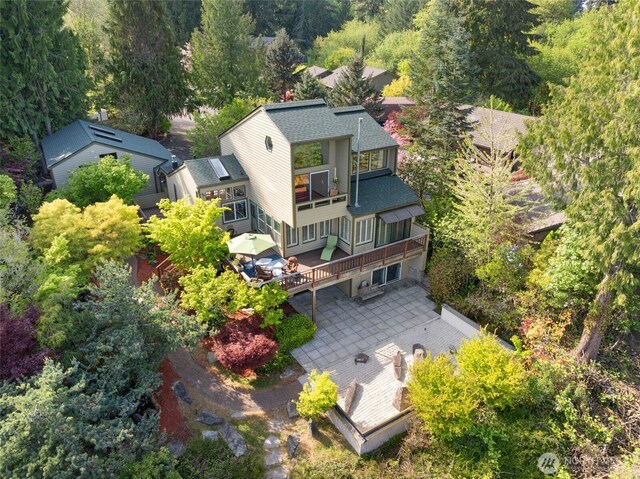 birds eye view of property with a wooded view