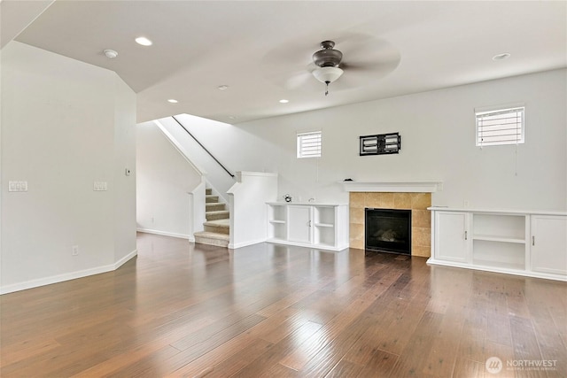 4000 Cameron Dr NE, Lacey, WA 98516 - unfurnished living room with a ceiling fan, wood finished floors, stairs, recessed lighting, and a tiled fireplace