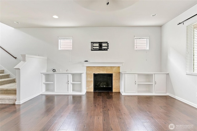 4000 Cameron Dr NE, Lacey, WA 98516 - unfurnished living room featuring dark wood-style floors, plenty of natural light, stairs, a fireplace, and recessed lighting
