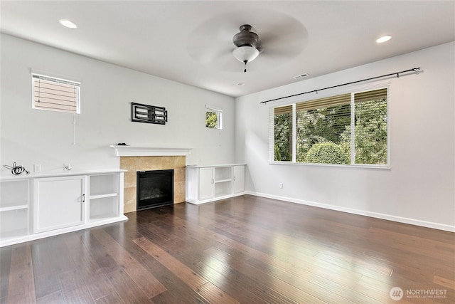 4000 Cameron Dr NE, Lacey, WA 98516 - unfurnished living room featuring a ceiling fan, a tiled fireplace, wood finished floors, and recessed lighting