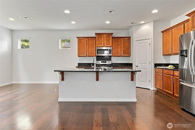 4000 Cameron Dr NE, Lacey, WA 98516 - kitchen featuring appliances with stainless steel finishes, brown cabinetry, dark countertops, and recessed lighting