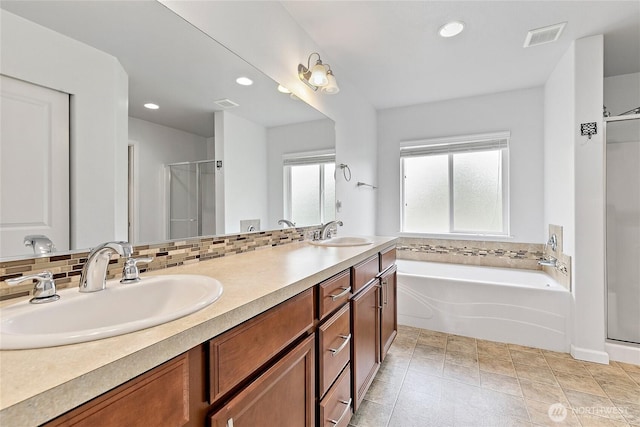 4000 Cameron Dr NE, Lacey, WA 98516 - full bath featuring double vanity, a stall shower, a garden tub, recessed lighting, and decorative backsplash
